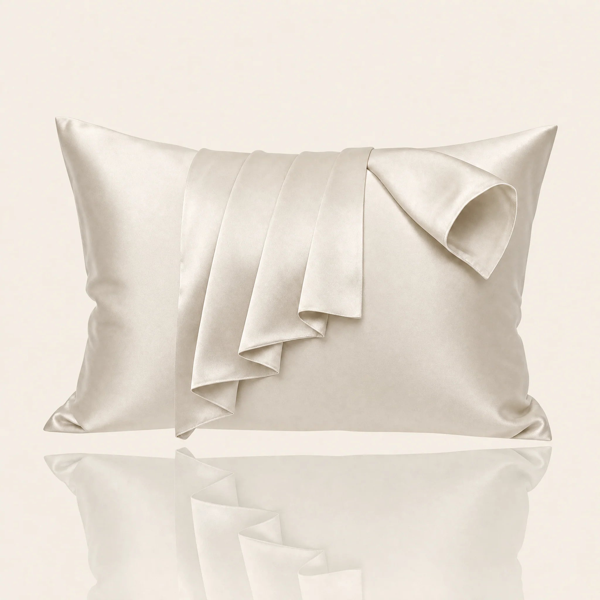 Somnia Sheen mulberry silk pillowcase in Beige, draped on a styled bed