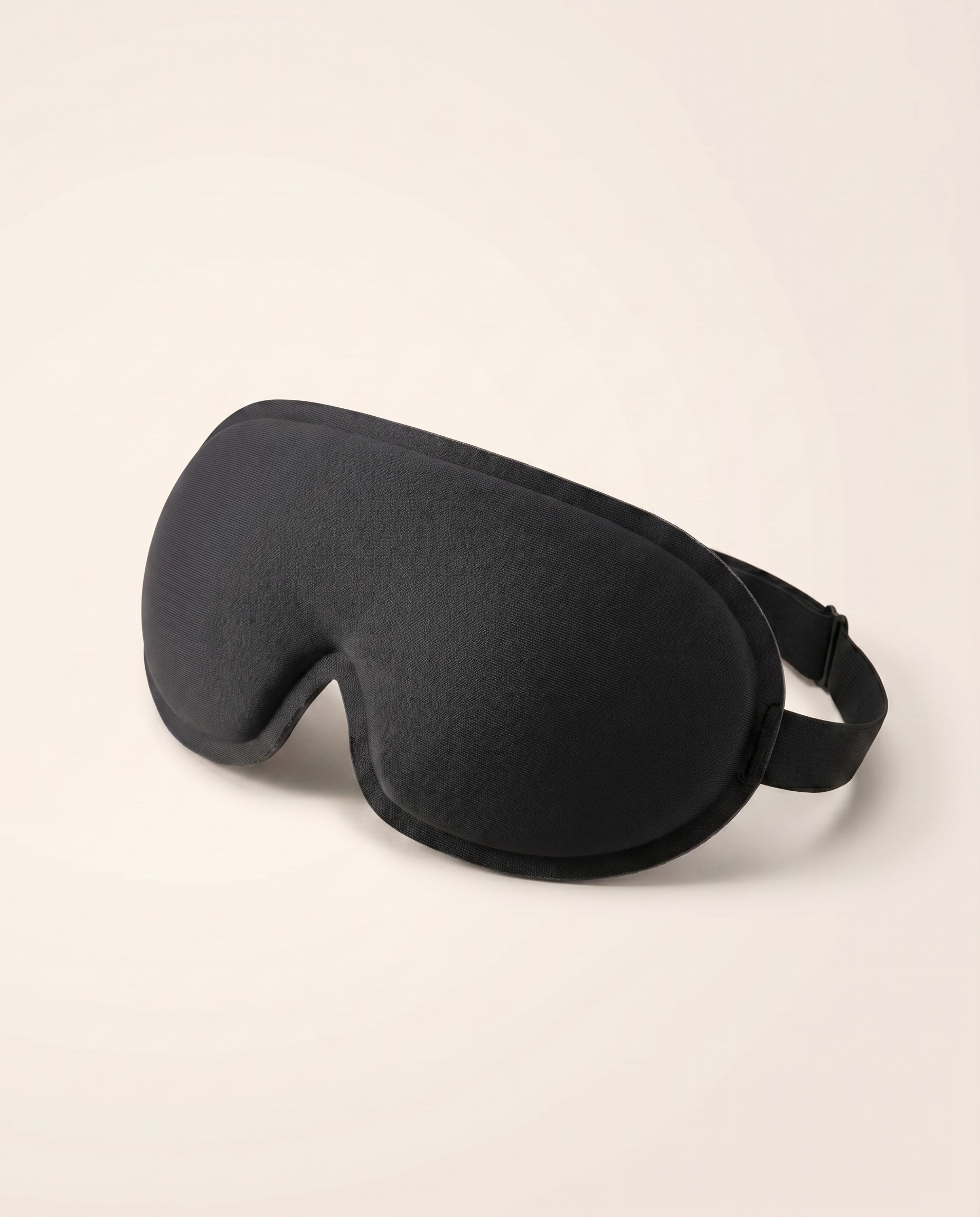 Somnia Sable 3D contour sleep mask in Jet black - front three-quarter view with adjustable strap